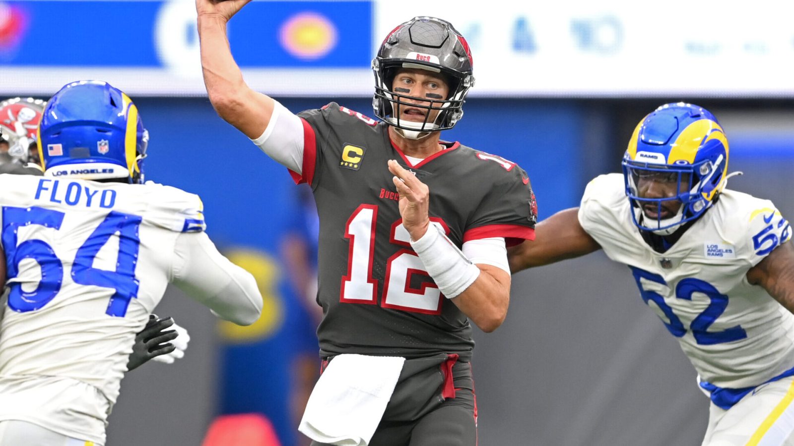 Tampa Bay Buccaneers quarterback Tom Brady throws a pass while getting pressured by Los Angeles Rams defensive players