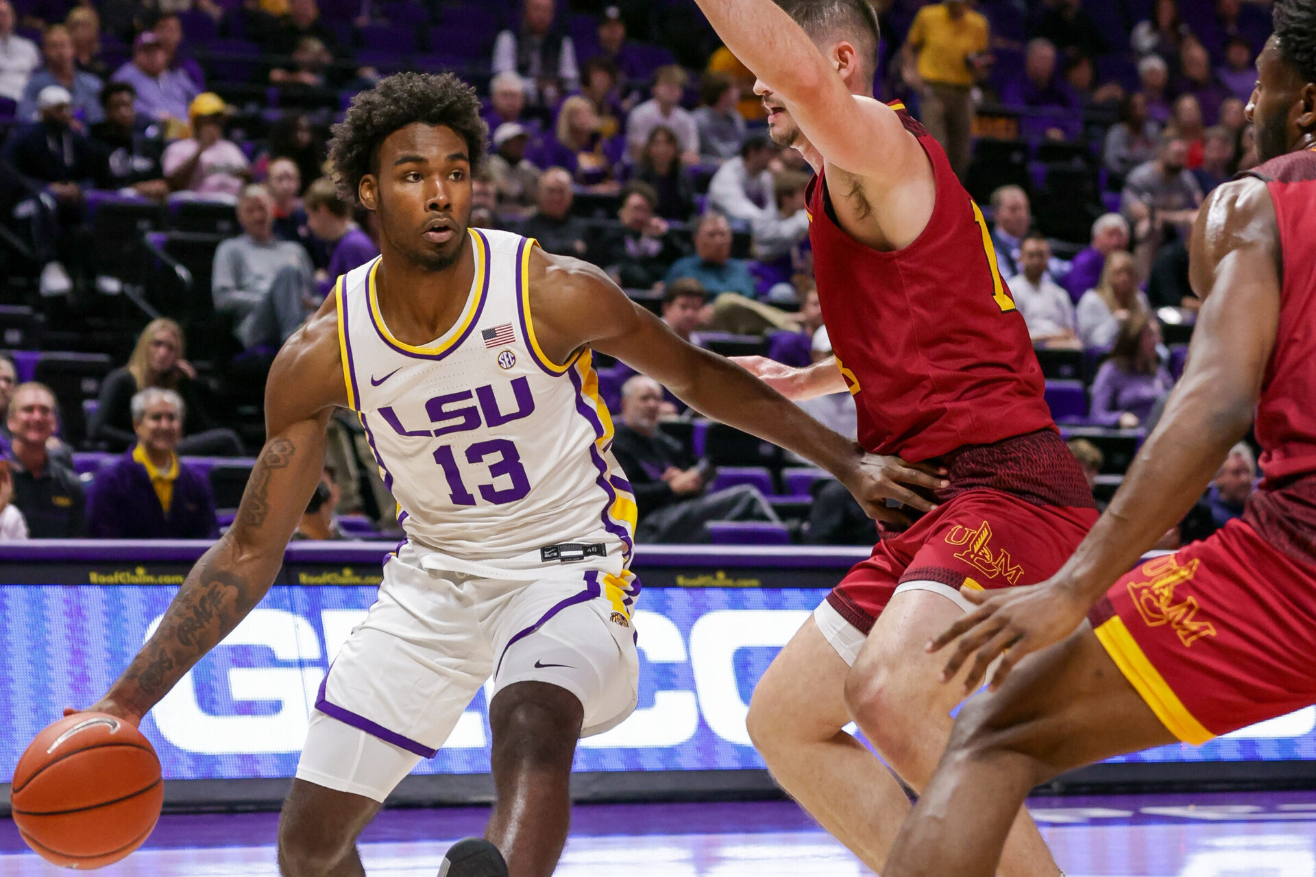 LSU Tigers forward Tari Eason (left) dribbles against Louisiana Monroe Warhawks