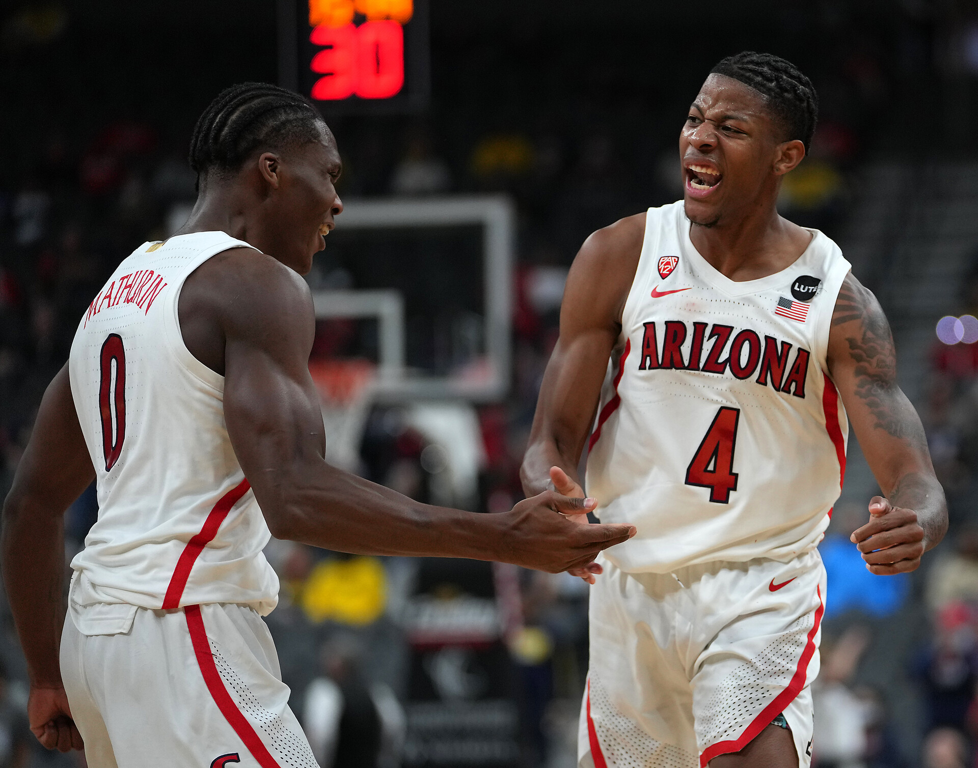 Arizona Wildcats guard Bennedict Mathurin (left) and Arizona Wildcats guard Dalen Terry (right) celebrate after a play against the Michigan Wolverines