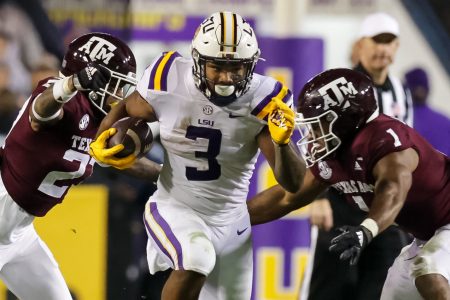 Nov 27, 2021; Baton Rouge, Louisiana, USA; LSU Tigers running back Tyrion Davis-Price (3) runs between Texas A&M Aggies defensive back Antonio Johnson (27) and linebacker Aaron Hansford (1) during the first half at Tiger Stadium. Mandatory Credit: Stephen Lew-USA TODAY Sports