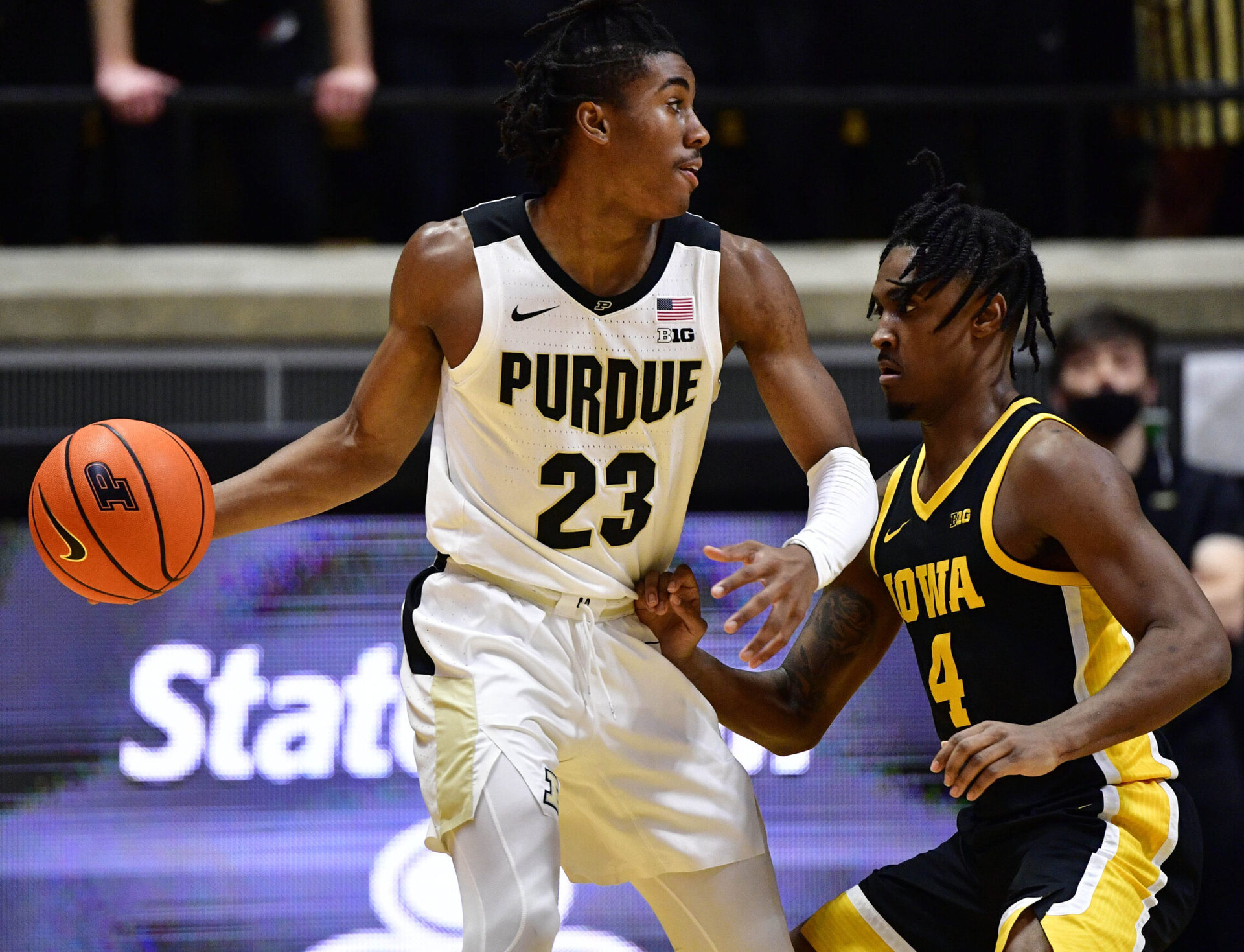 Purdue Boilermakers guard Jaden Ivey (left) looks to make a move against Iowa Hawkeyes guard Ahron Ulis (right) during a Big Ten basketball game