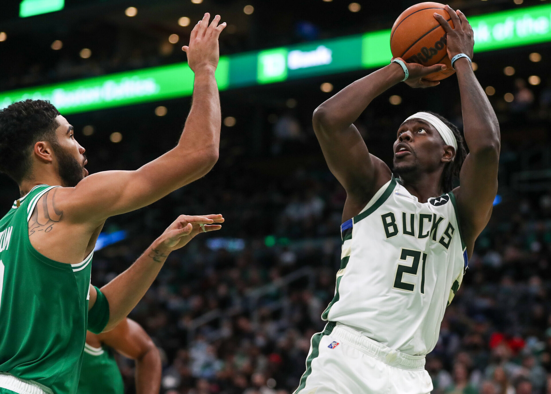 Milwaukee Bucks guard Jrue Holiday (right) shoots over Boston Celtics forward Jayson Tatum (left)