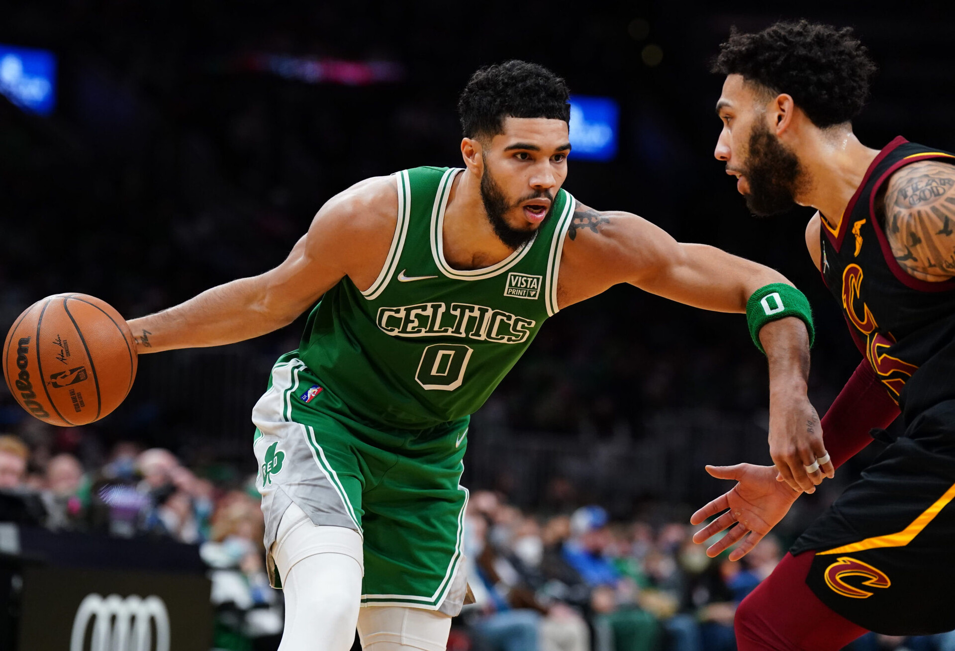 Boston Celtics forward Jayson Tatum (left) drives the ball against Cleveland Cavaliers guard Denzel Valentine (right)