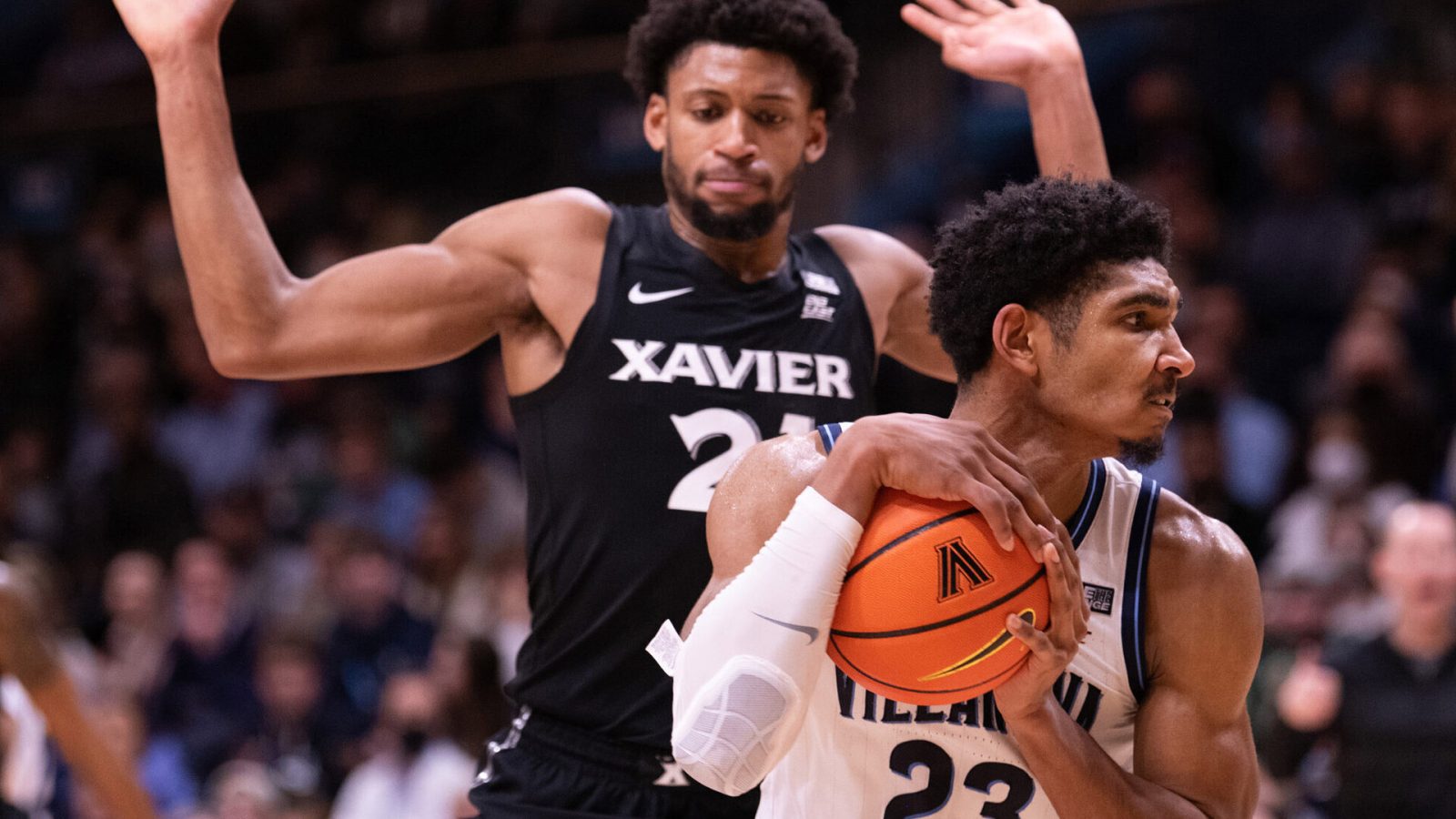 Wednesday college basketball betting -- Villanova forward Jermaine Samuels (right) controls the ball while be defended by Xavier forward Jack Nunge (left)
