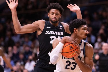 Wednesday college basketball betting -- Villanova forward Jermaine Samuels (right) controls the ball while be defended by Xavier forward Jack Nunge (left)