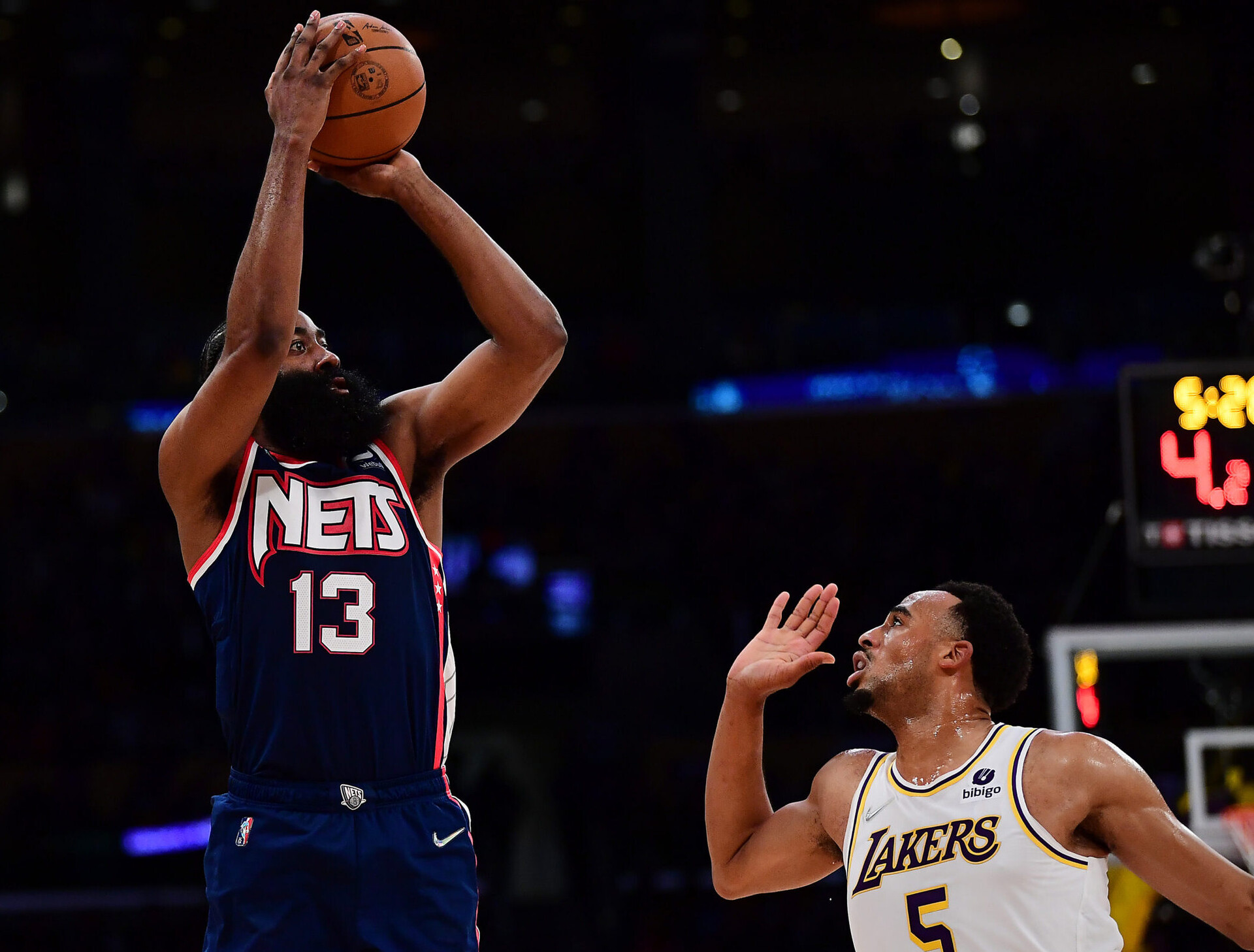 Brooklyn Nets guard James Harden (left) shoots the basketball over Los Angeles Lakers guard Talen Horton-Tucker (right)