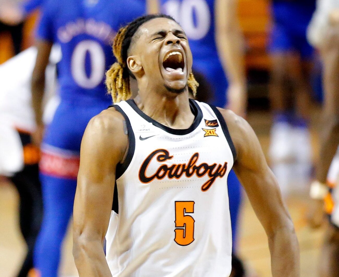 Oklahoma State's Rondel Walker (5) celebrates in the second half during the men's college basketball game between the Oklahoma State Cowboys and the Kansas Jayhawks at Gallagher-Iba Arena in Stillwater, Okla., Tuesday, Jan. 12, 2021. Oklahoma State beat Kansas 75-70. Poy0120