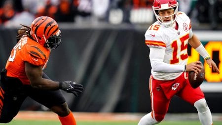 Kansas City Chiefs quarterback Patrick Mahomes (right) is chased out of the pocket by Cincinnati Bengals defensive tackle Larry Ogunjobi (left)