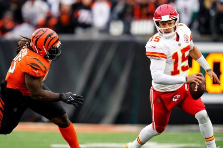 Kansas City Chiefs quarterback Patrick Mahomes (right) is chased out of the pocket by Cincinnati Bengals defensive tackle Larry Ogunjobi (left)