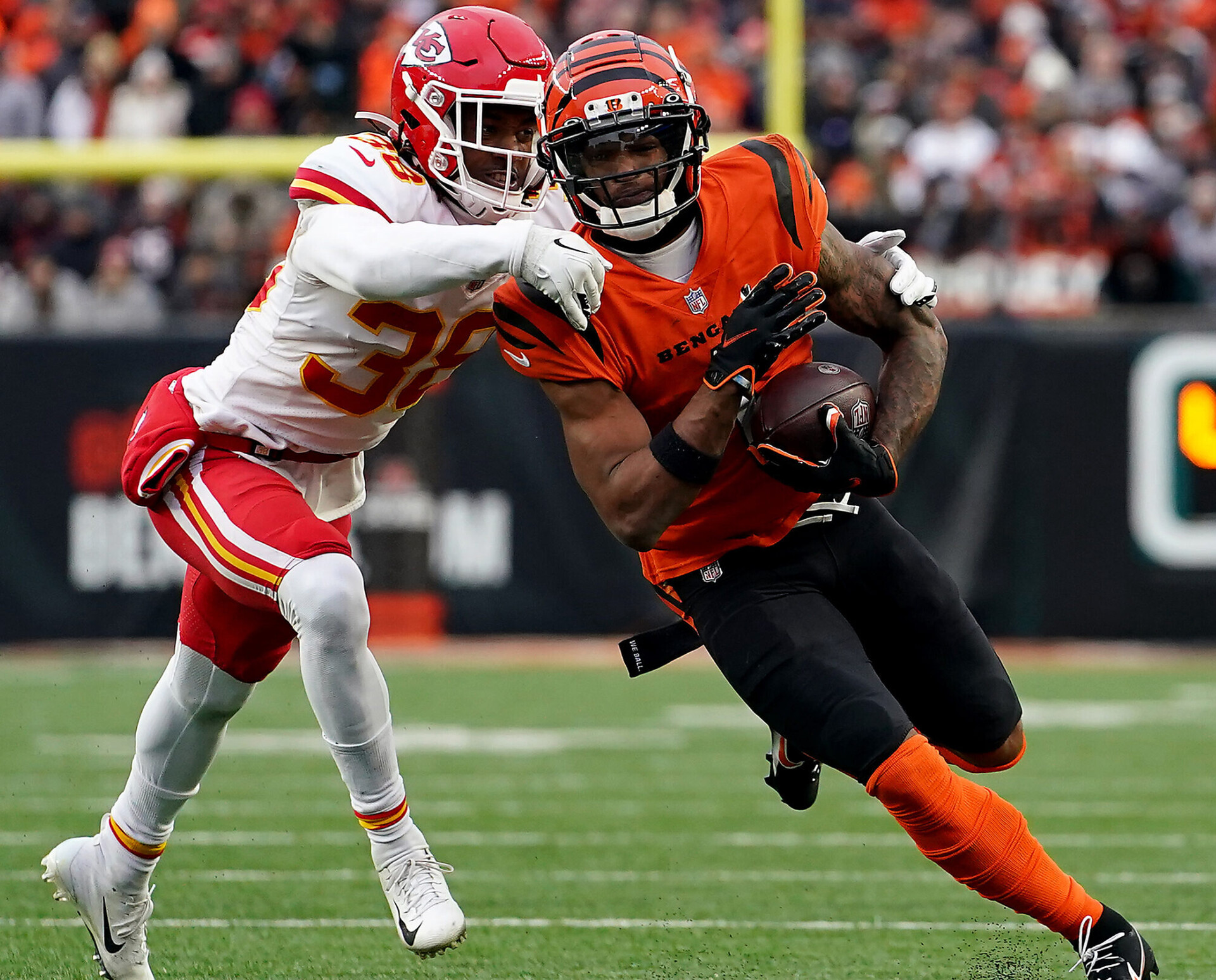 Cincinnati Bengals wide receiver Ja'Marr Chase (right) runs for extra yardage after a catch as Kansas City Chiefs cornerback L'Jarius Sneed (left) attempts to make a tackle