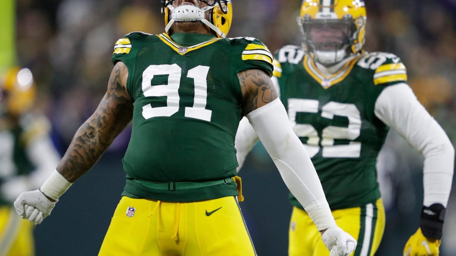 Green Bay Packers outside linebacker Preston Smith (left) celebrates a sack against the Minnesota Vikings