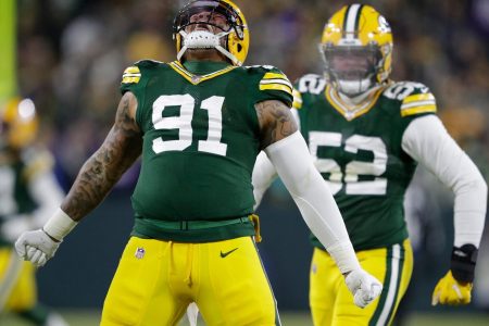 Green Bay Packers outside linebacker Preston Smith (left) celebrates a sack against the Minnesota Vikings