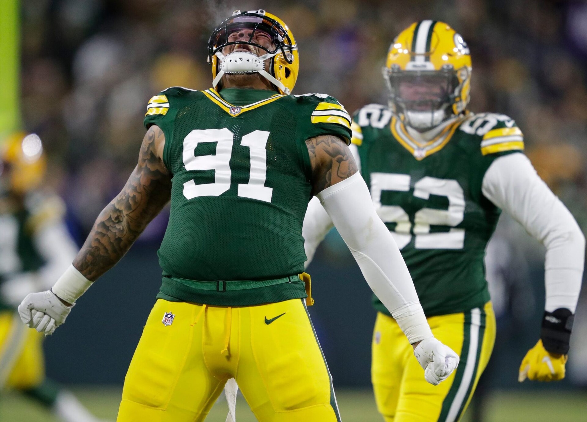 Green Bay Packers outside linebacker Preston Smith (left) celebrates a sack against the Minnesota Vikings