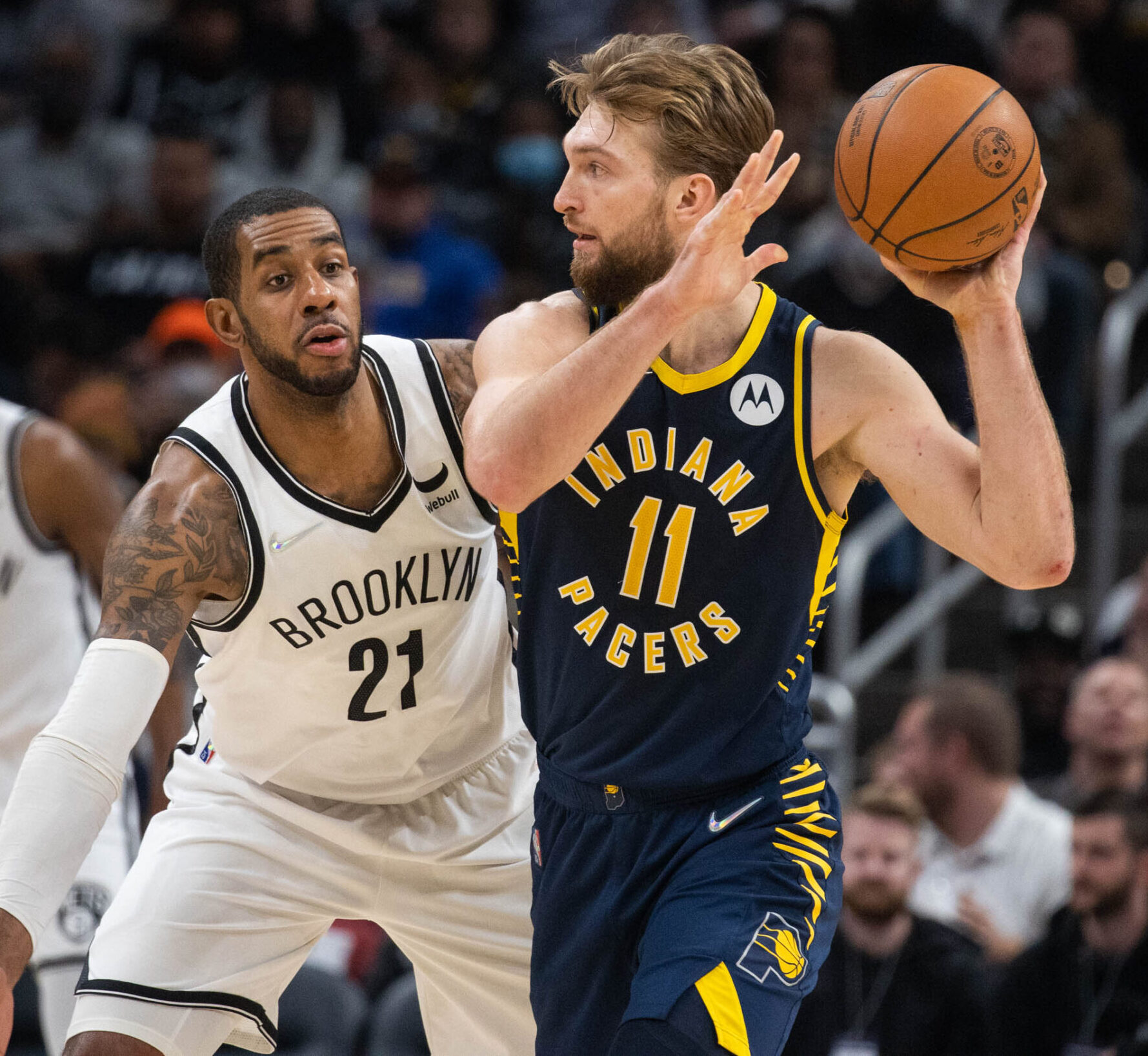 Indiana Pacers forward Domantas Sabonis (right) looks to pass the ball while Brooklyn Nets center LaMarcus Aldridge (left) defends