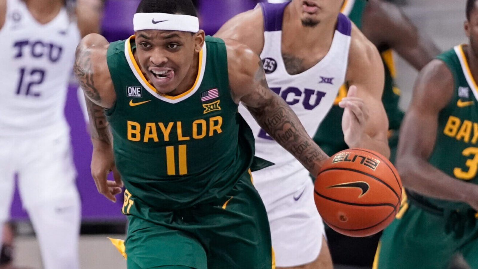 Baylor Bears guard James Akinjo dribbles the ball up court against the TCU Horned Frogs during a Big 12 basketball game