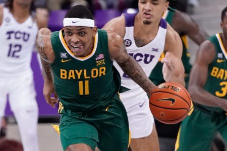 Baylor Bears guard James Akinjo dribbles the ball up court against the TCU Horned Frogs during a Big 12 basketball game