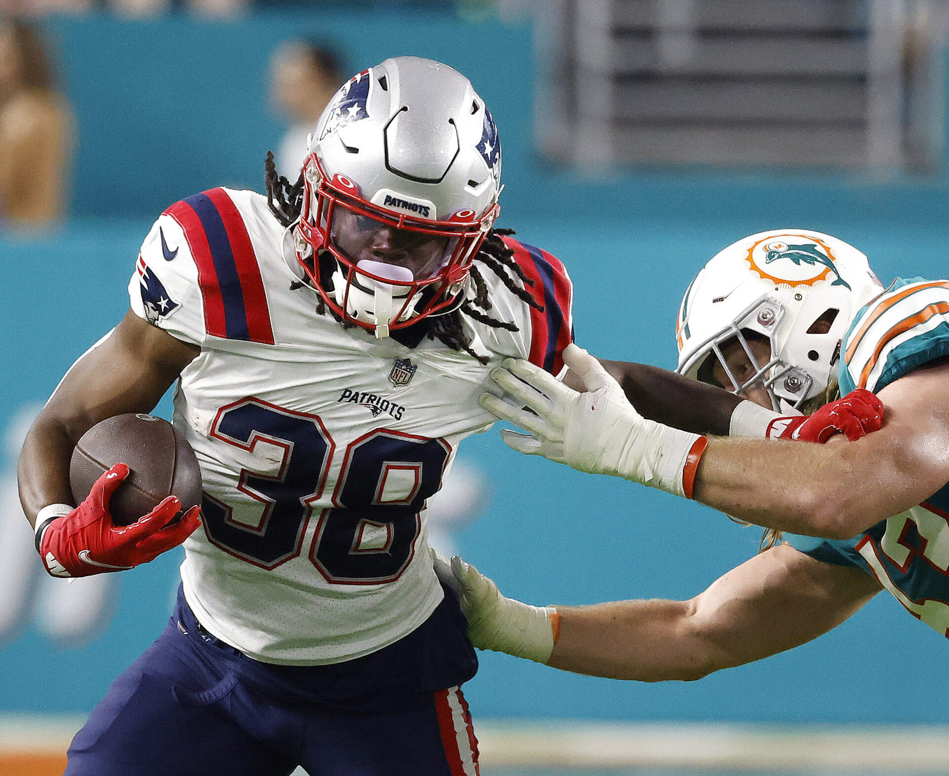 Jan 9, 2022; Miami Gardens, Florida, USA; Miami Dolphins linebacker Andrew Van Ginkel (43) tackles New England Patriots runningback Rhamondre Stevenson (38) during the third quarter at Hard Rock Stadium.