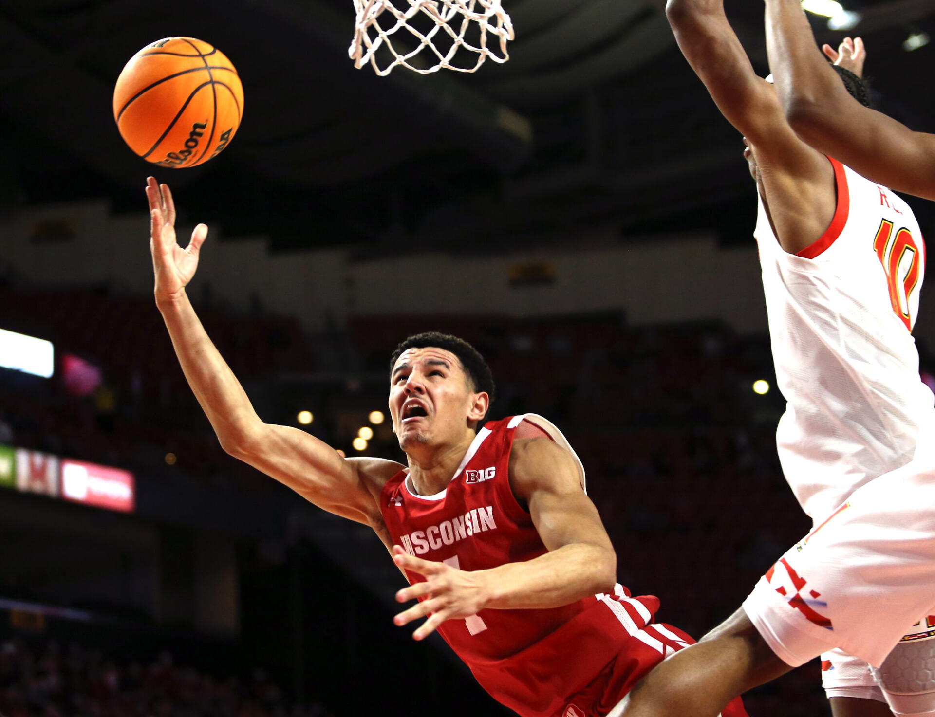 Wisconsin Badgers guard Johnny Davis (left) shoots the basketball against the Maryland Terrapins