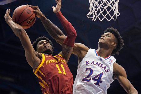 Kansas Jayhawks forward K.J. Adams (right) blocks the shot of Iowa State Cyclones guard Tyrese Hunter (left) during a Big 12 basketball game.