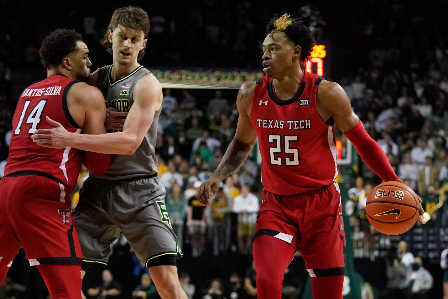 Texas Tech Red Raiders guard Adonis Arms (right) controls the ball against the Baylor Bears during the first half of a Big 12 basketball game.