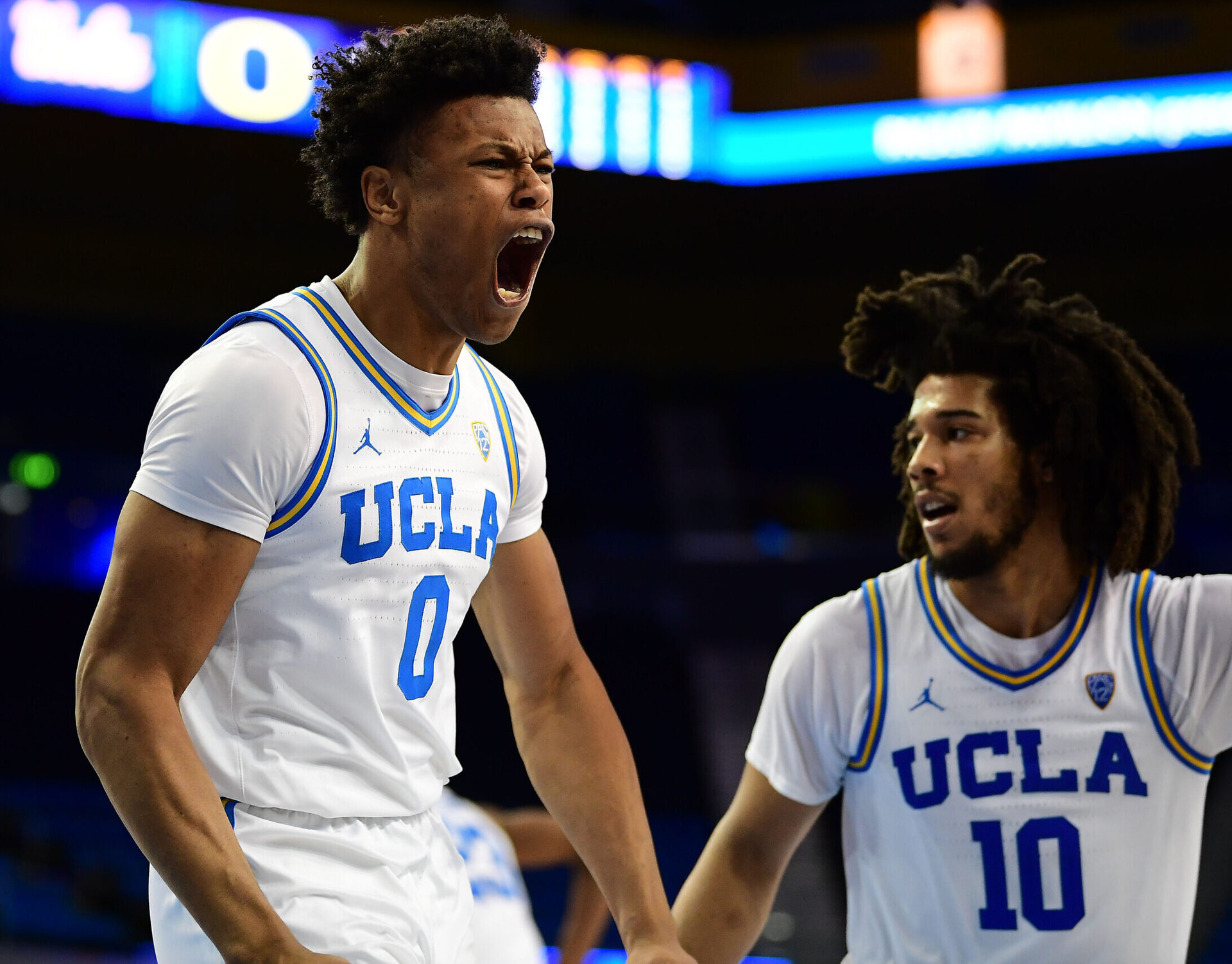 UCLA Bruins guard Jaylen Clark (left) reacts after scoring a basket and drawing the foul against the Oregon Ducks in a Pac-12 basketball game