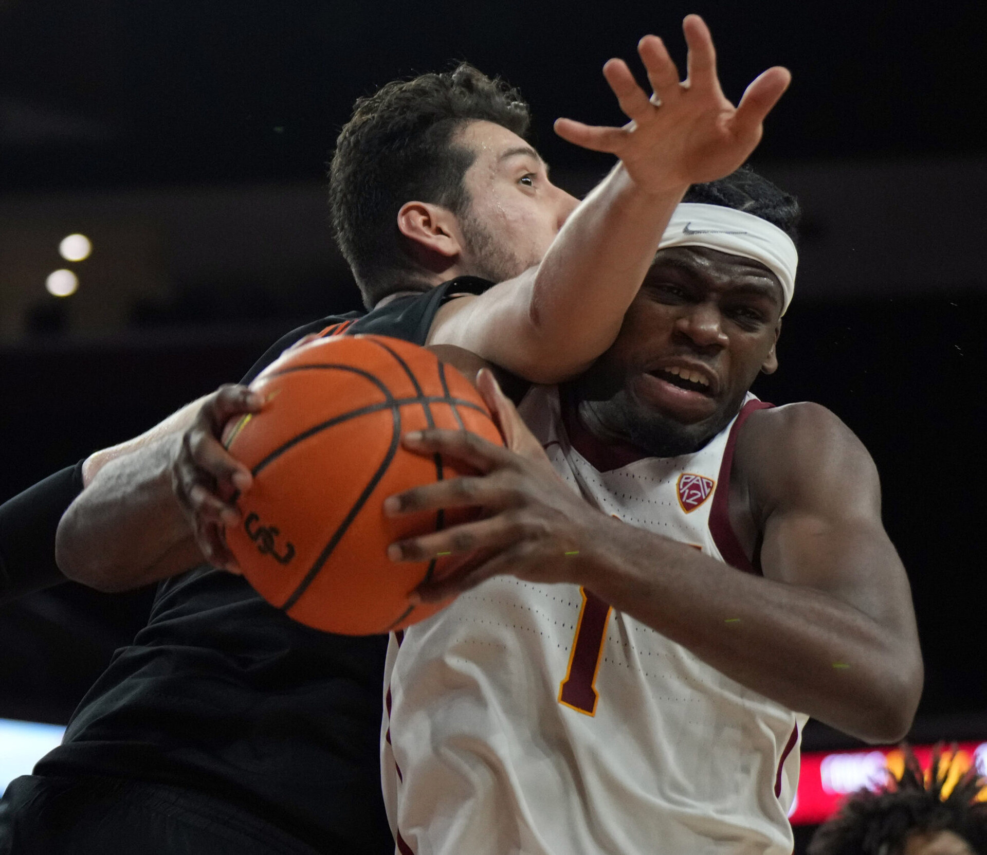 Jan 13, 2022; Los Angeles, California, USA; Southern California Trojans forward Chevez Goodwin (1) and Oregon State Beavers center Roman Silva (12) battle for the ball in the second half at Galen Center. USC defeated OSU 81-71.