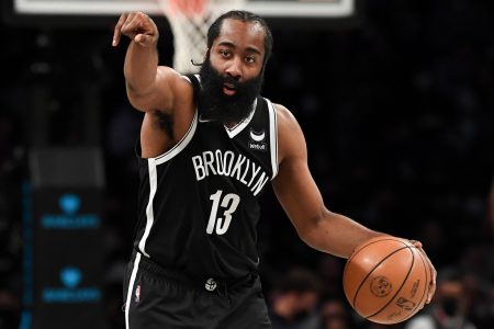 Brooklyn Nets guard James Harden directs his team with his right hand while dribbling the basketball with his left hand against the New Orleans Pelicans