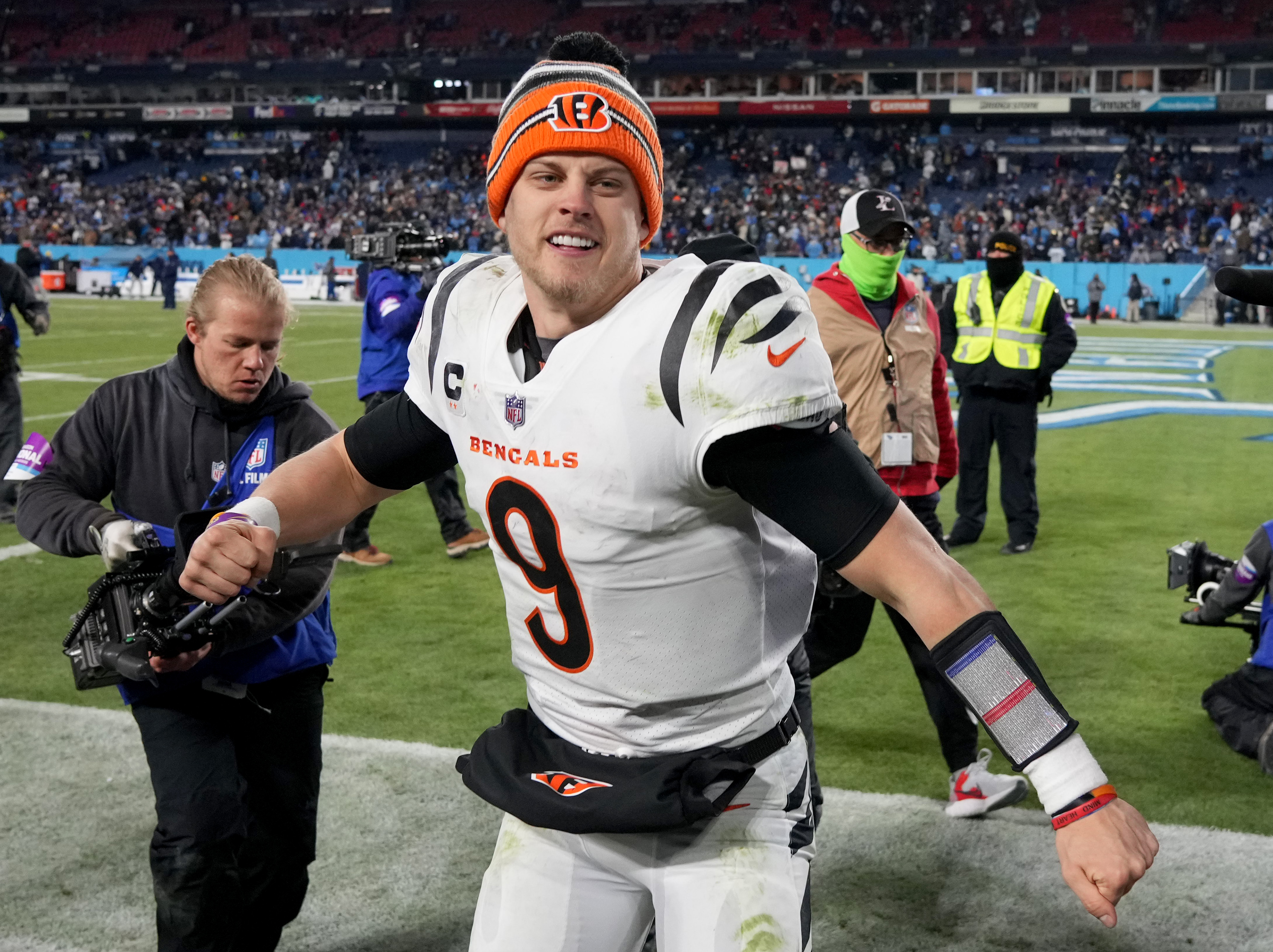 Jan 22, 2022; Nashville, Tennessee, USA; Cincinnati Bengals quarterback Joe Burrow (9) celebrates after defeating the Tennessee Titans 19-16 during the AFC Divisional playoff football game at Nissan Stadium.
