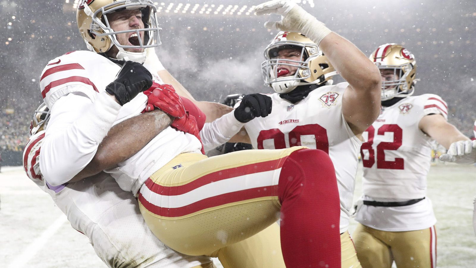 Jan 22, 2022; Green Bay, Wisconsin, USA; San Francisco 49ers kicker Robbie Gould (9) celebrates with teammate after kicking the game winning field goal during a NFC Divisional playoff football game against the Green Bay Packers at Lambeau Field. Mandatory Credit: Jeff Hanisch-USA TODAY Sports