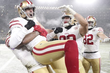 Jan 22, 2022; Green Bay, Wisconsin, USA; San Francisco 49ers kicker Robbie Gould (9) celebrates with teammate after kicking the game winning field goal during a NFC Divisional playoff football game against the Green Bay Packers at Lambeau Field. Mandatory Credit: Jeff Hanisch-USA TODAY Sports
