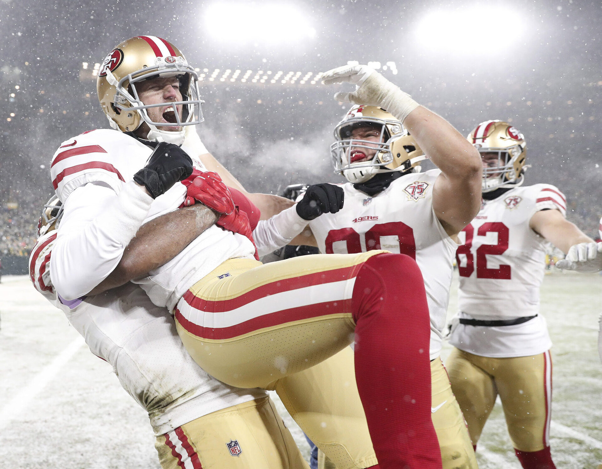 Jan 22, 2022; Green Bay, Wisconsin, USA; San Francisco 49ers kicker Robbie Gould (9) celebrates with teammate after kicking the game winning field goal during a NFC Divisional playoff football game against the Green Bay Packers at Lambeau Field. Mandatory Credit: Jeff Hanisch-USA TODAY Sports
