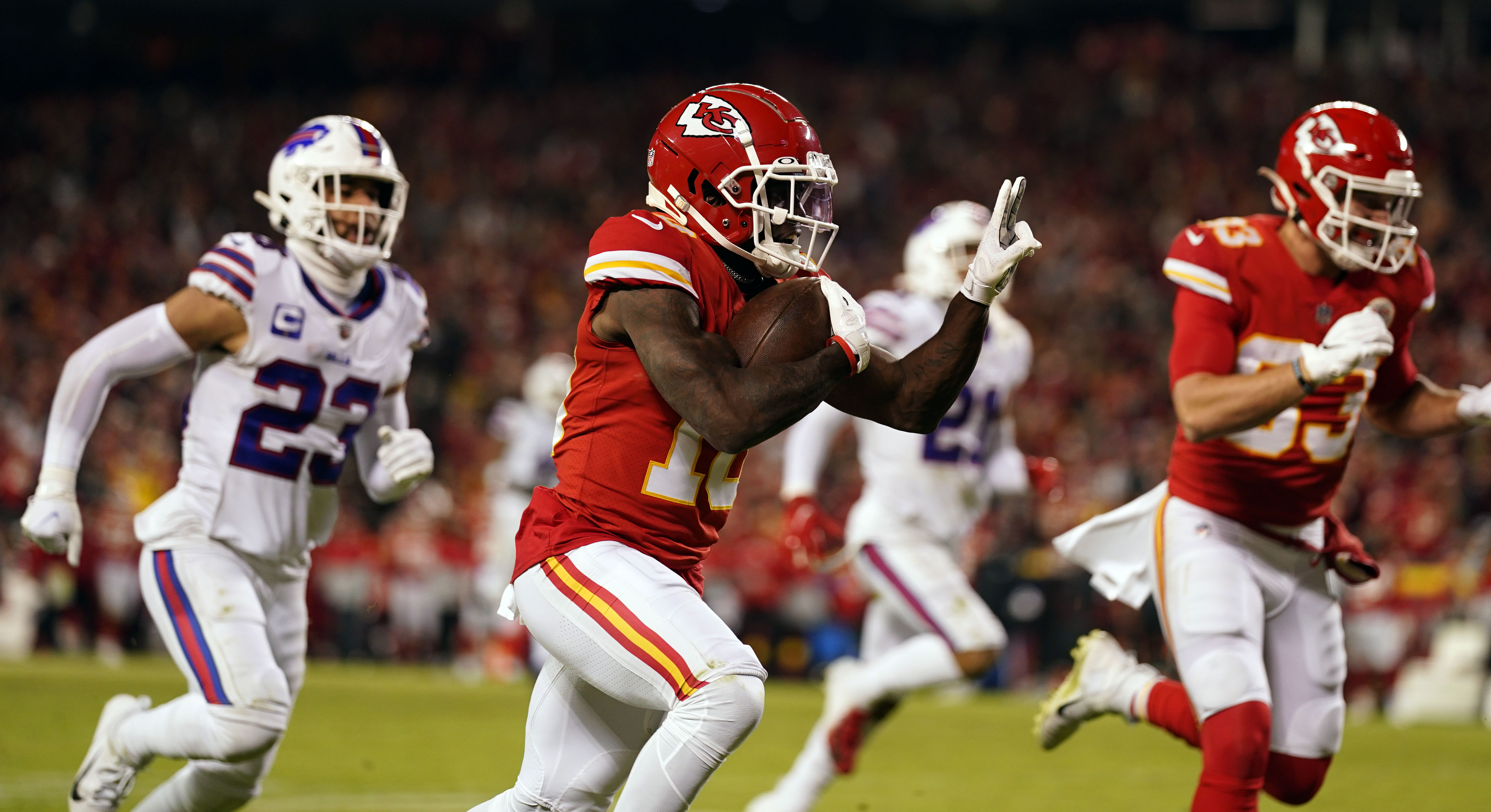 Jan 23, 2022; Kansas City, Missouri, USA; Kansas City Chiefs wide receiver Tyreek Hill (10) carries the ball up the field for a touchdown against the Buffalo Bills during the fourth quarter of the AFC Divisional playoff football game at GEHA Field at Arrowhead Stadium.