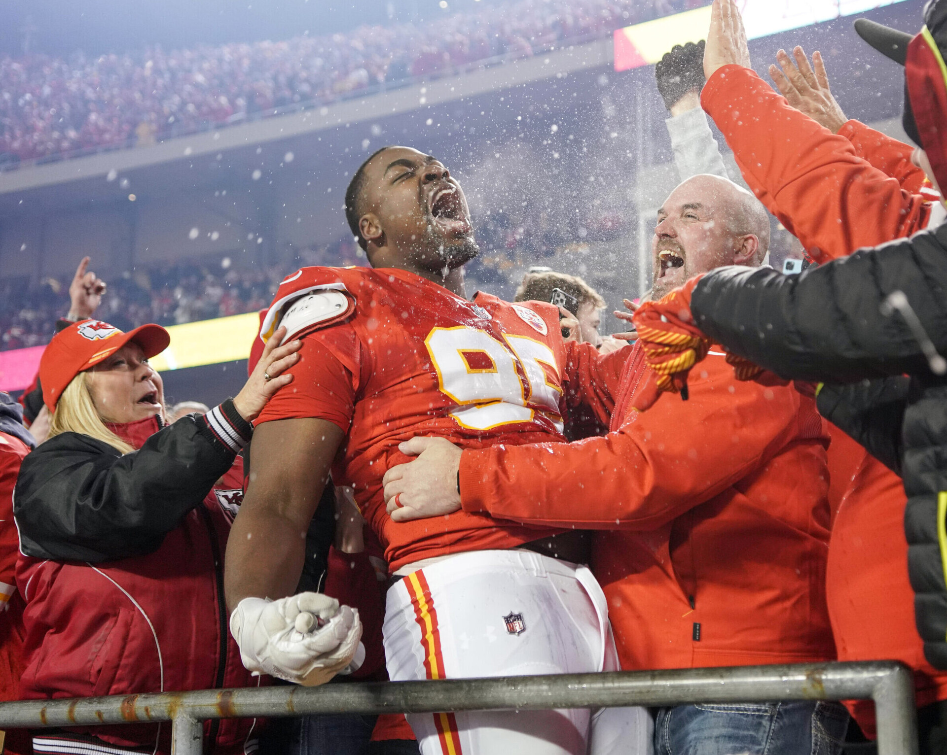 Kansas City Chiefs defensive end Chris Jones (95) celebrates with fans in the stands after his team's overtime victory over the Buffalo Bills an AFC Divisional playoff game