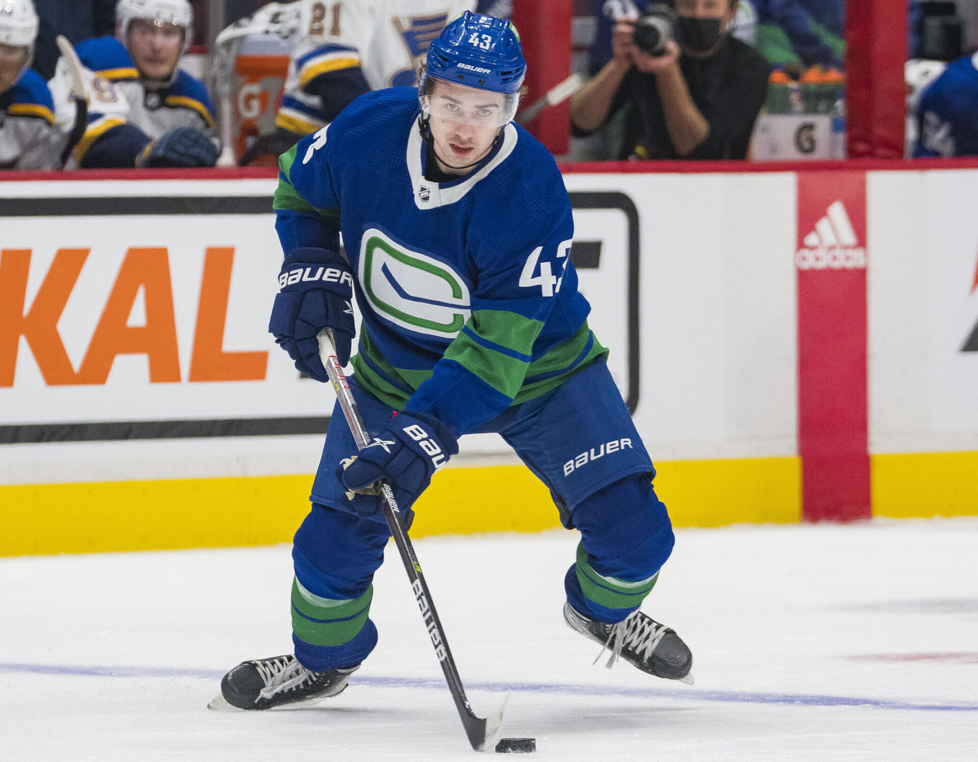 Vancouver Canucks defenseman Quinn Hughes handles the puck during a game against the St. Louis Blues