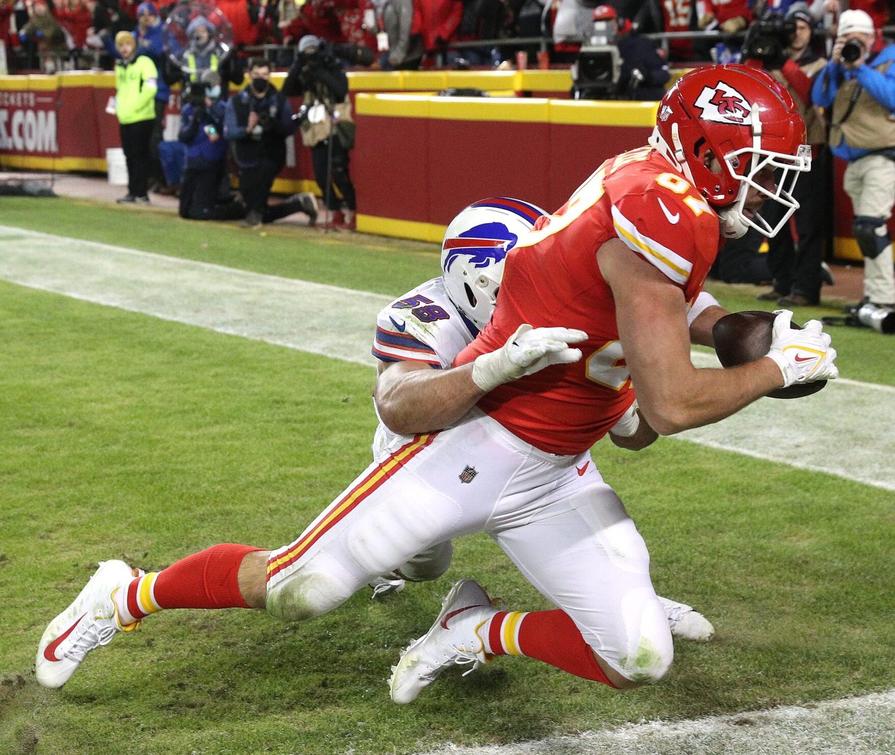 Jan 23, 2022; Kansas City, Missouri, USA; Kansas City Chiefs tight end Travis Kelce catches the game-winning touchdown in overtime in the AFC Divisional Round at Highmark Stadium.