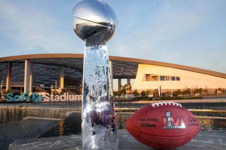 The Vince Lombardi trophy and an NFL Wilson official Duke football with Super Bowl LVI logo are seen at SoFi Stadium, site of Super Bowl 56