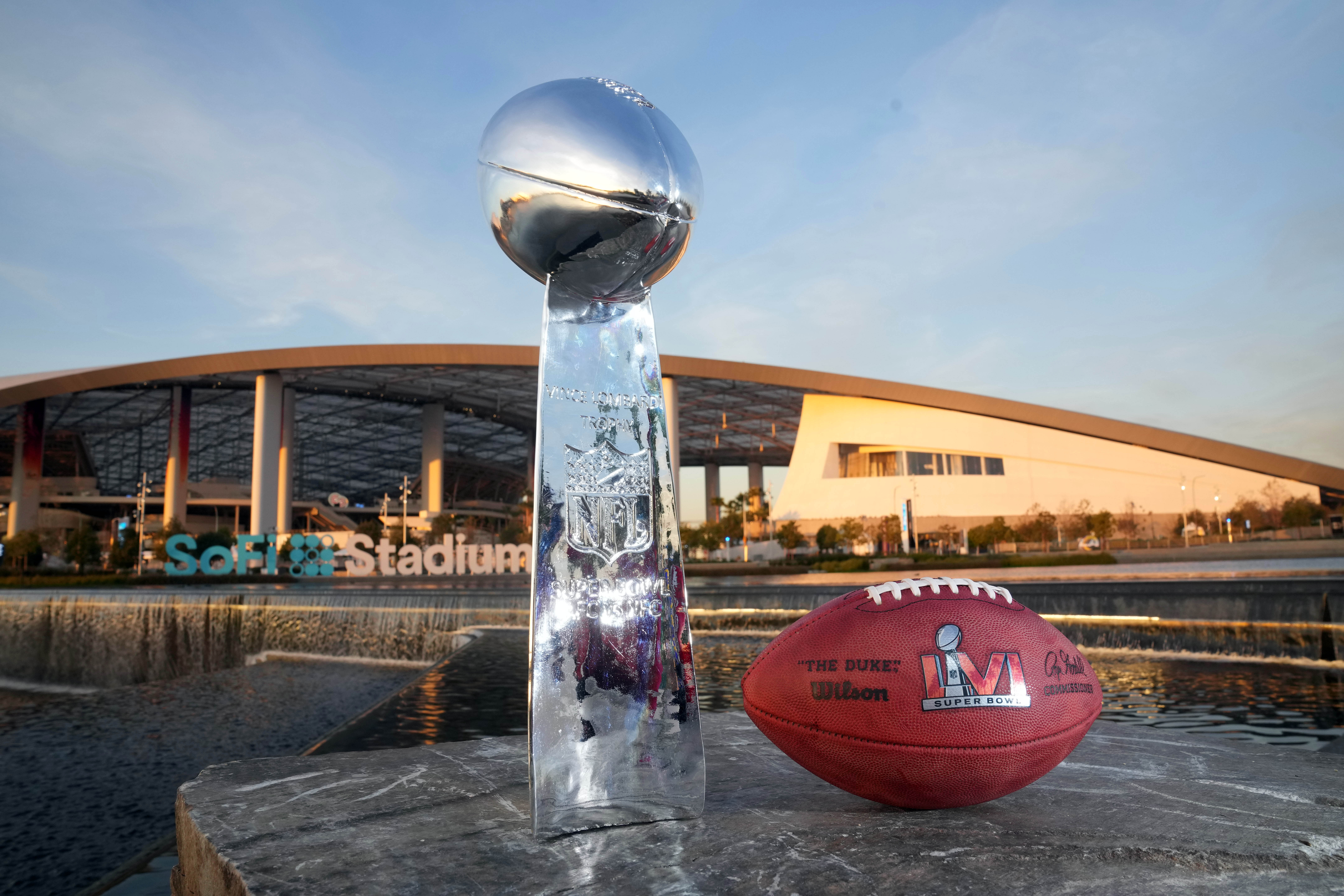 The Vince Lombardi trophy and an NFL Wilson official Duke football with Super Bowl LVI logo are seen at SoFi Stadium, site of Super Bowl 56