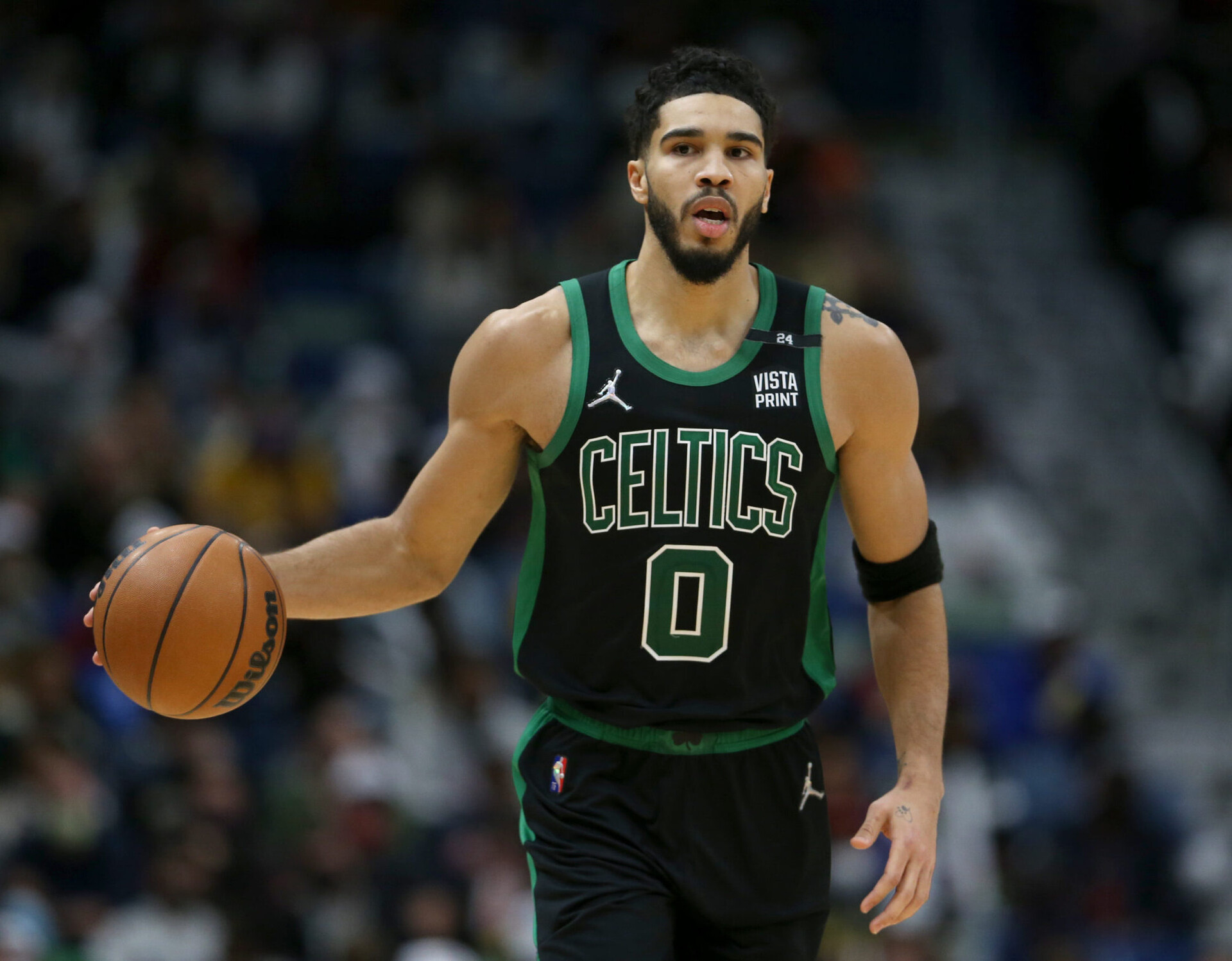 Boston Celtics forward Jayson Tatum dribbles the ball up court against the New Orleans Pelicans