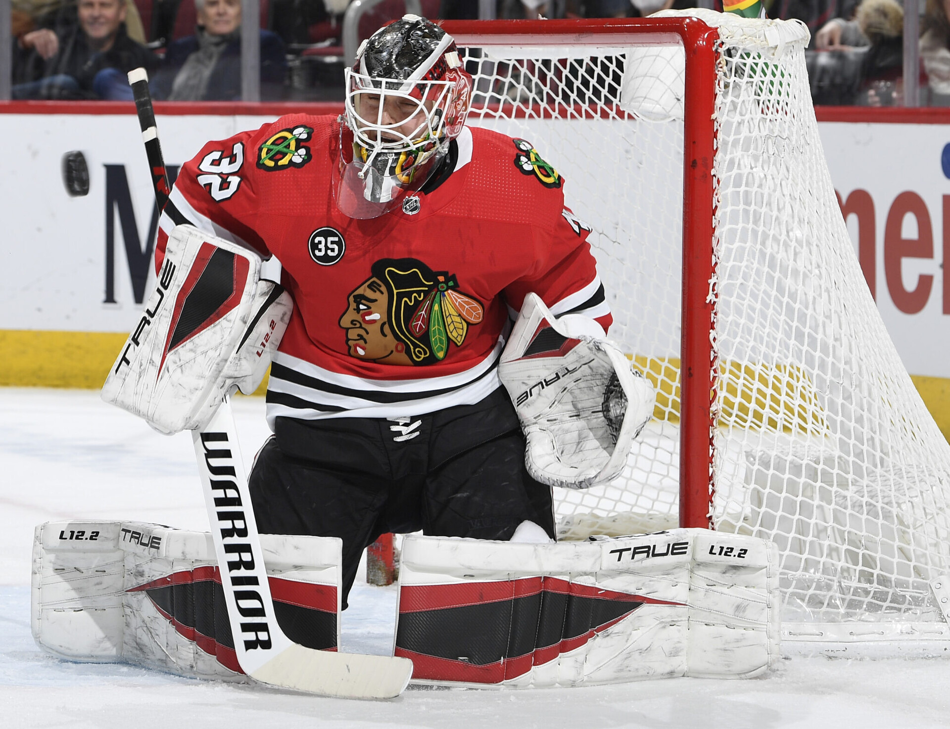 Chicago Blackhawks goalie Kevin Lankinen prepares to make a save on the puck during a game against the Minnesota Wild