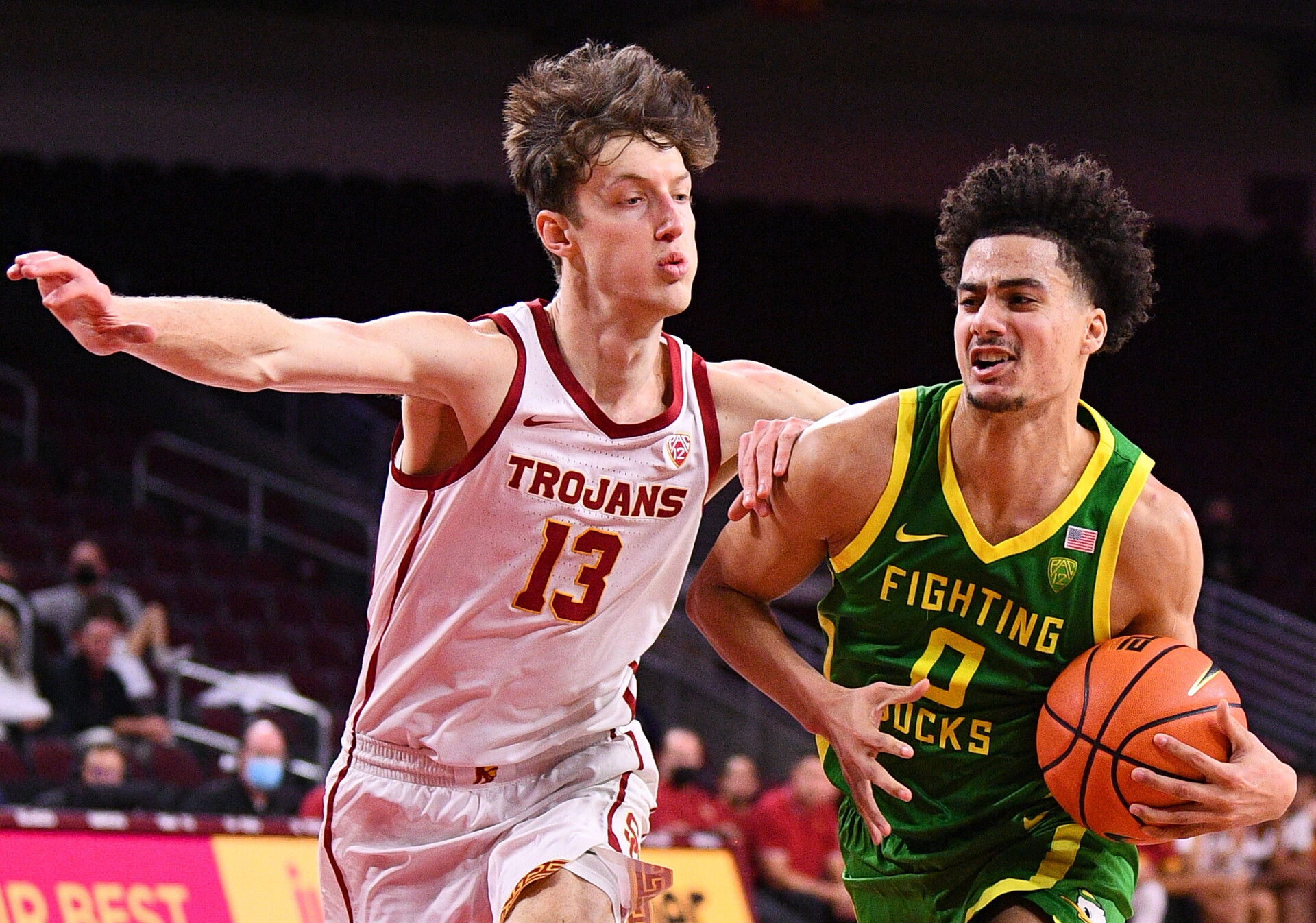 Oregon Ducks guard Will Richardson (left) drives past USC Trojans guard Drew Peterson (right) as he makes his way to the basket during a Pac-12 basketball game