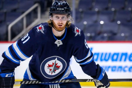 Kyle Connor #81 of the Winnipeg Jets prepares for a third period face-off against the Florida Panthers at Canada Life Centre on January 25, 2022 in Winnipeg, Manitoba, Canada.