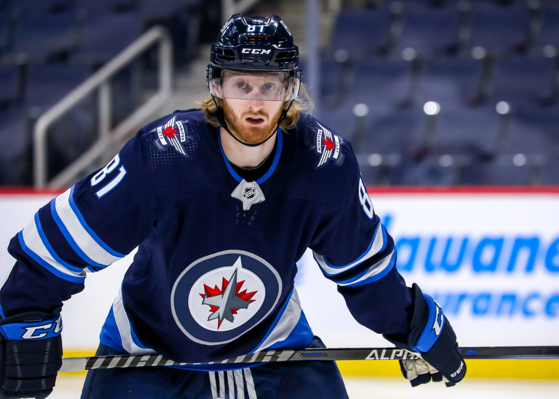 Kyle Connor #81 of the Winnipeg Jets prepares for a third period face-off against the Florida Panthers at Canada Life Centre on January 25, 2022 in Winnipeg, Manitoba, Canada.