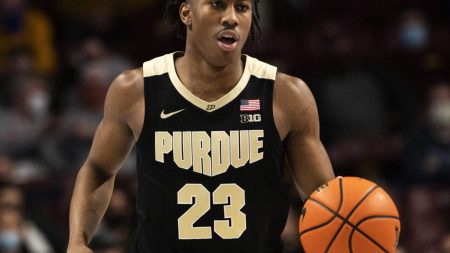 Purdue Boilermakers guard Jaden Ivey brings the ball up the court in a Big Ten basketball game against the Minnesota Golden Gophers