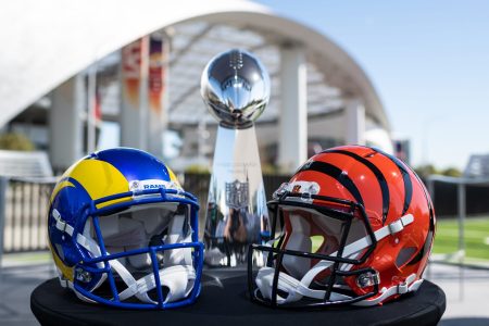 The helmets of the Super Bowl participants Los Angeles Rams (left) and Cinncinati Bengals (right) stand on a table in front of the Vince Lombardy Trophy, which the winner receives