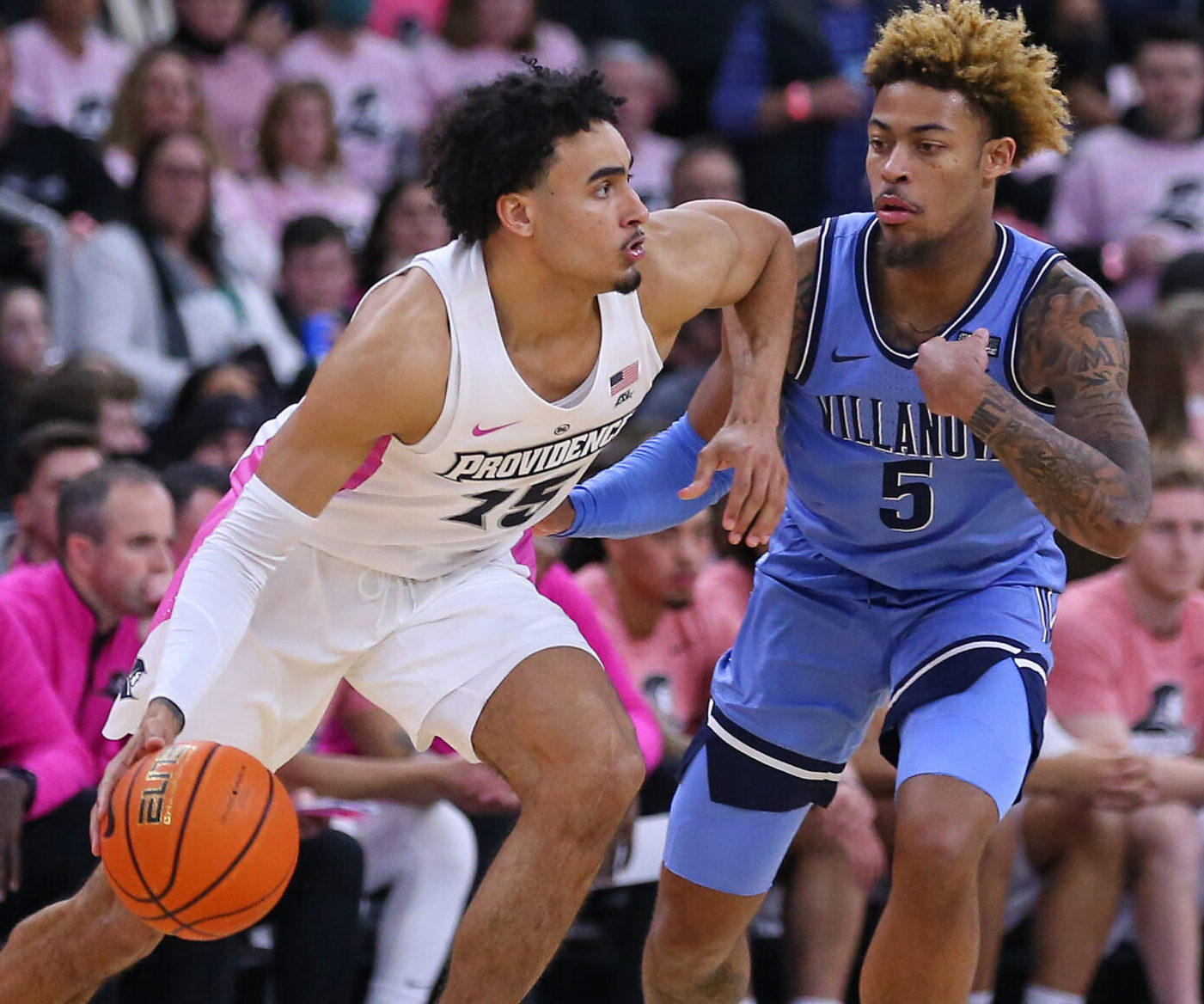 Villanova Wildcats guard Justin Moore (let) defends Providence Friars forward Justin Minaya (right) during a Big East college basketball game