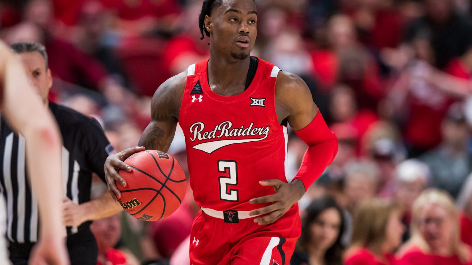 Guard Davion Warren #2 of the Texas Tech Red Raiders handles the ball during the first half of the college basketball game against the Iowa State Cyclones at United Supermarkets Arena on January 18, 2022 in Lubbock, Texas.