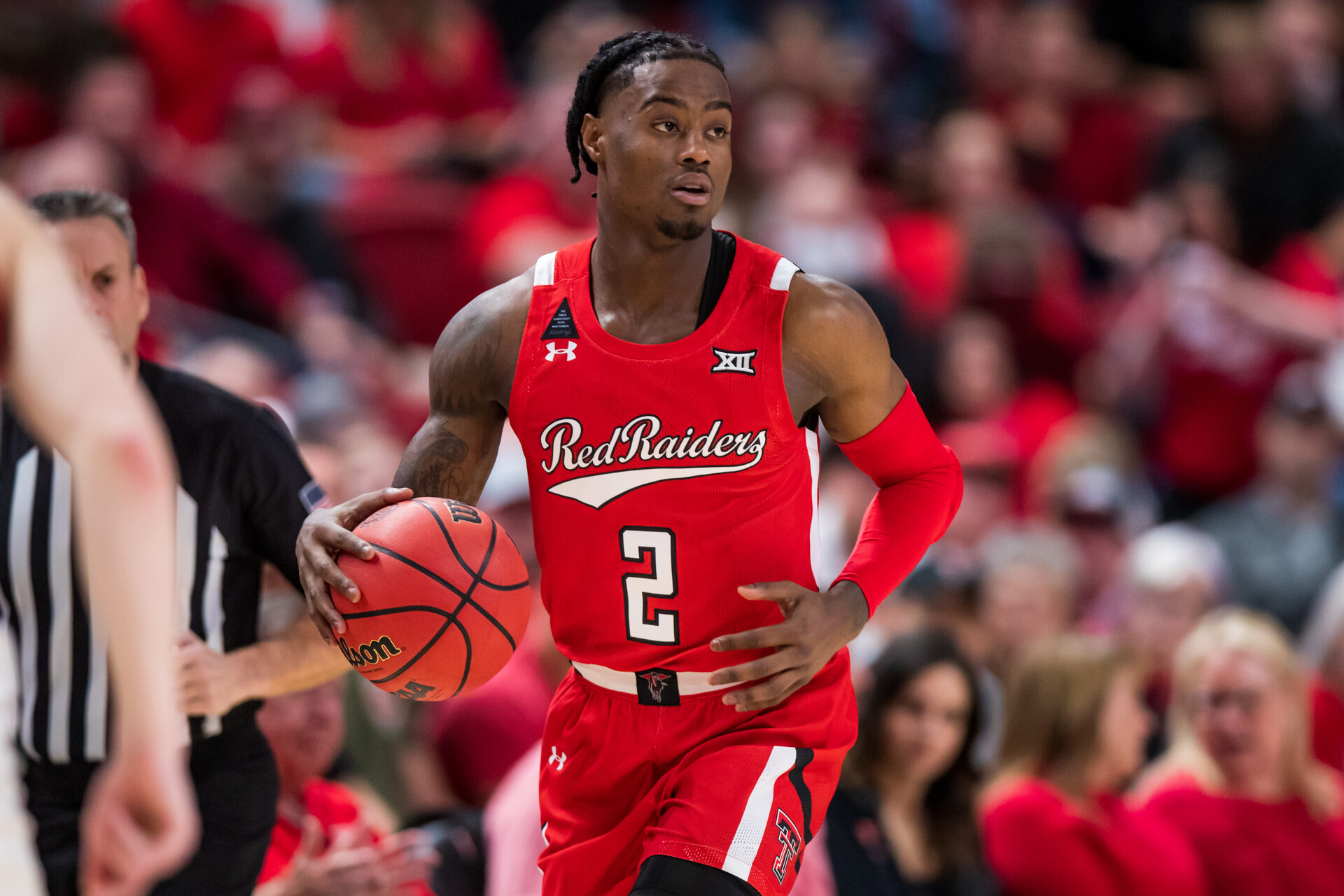 Guard Davion Warren #2 of the Texas Tech Red Raiders handles the ball during the first half of the college basketball game against the Iowa State Cyclones at United Supermarkets Arena on January 18, 2022 in Lubbock, Texas.