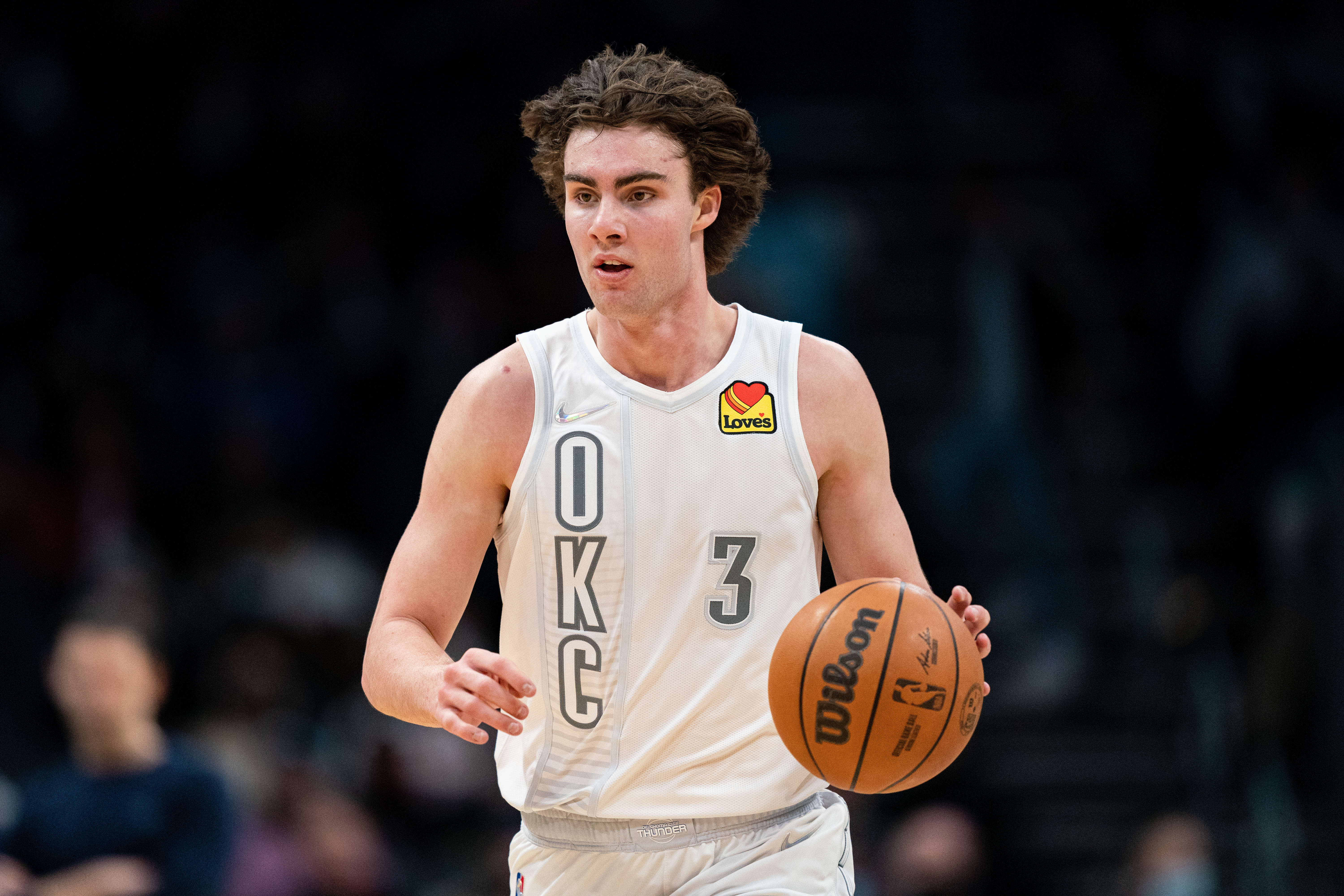 Josh Giddey #3 of the Oklahoma City Thunder brings the ball up court against the Charlotte Hornets during their game at Spectrum Center on January 21, 2022 in Charlotte, North Carolina.