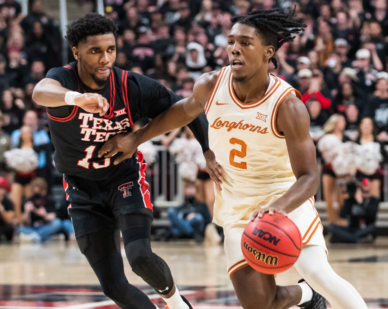 Texas Longhorns guard Marcus Carr (right) dribbles the ball against Texas Tech guard Mylik Wilson (left) during a Big 12 college basketball game