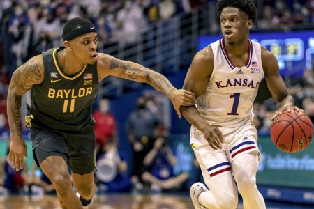Baylor Bears guard James Akinjo (left) attempts to defend Kansas Jayhawks guard Joseph Yesufu during a Big 12 basketball game